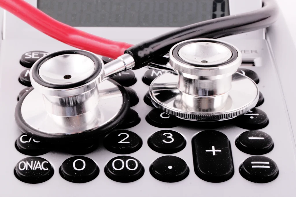 Stethoscope on a calculator representing medical billing