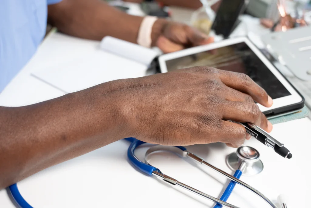 Provider using a tablet next to a stethoscope